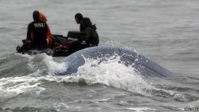 South Korean Navy's SSU (Ship Salvage Unit) members take part in the rescue operation