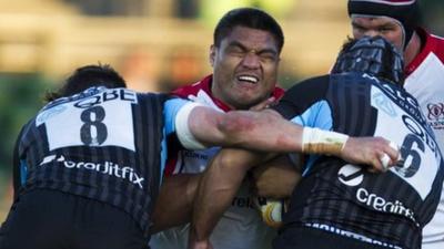 Nick Williams is tackled by two Glasgow players