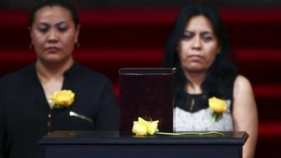 Two women stand behind the urn containing the ashes of Colombian Nobel laureate Gabriel Garcia Marquez