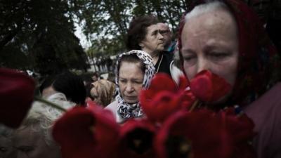 Ukrainian women attend the funeral of the three pro-Russians killed last Sunday at a checkpoint in Sloviansk, Ukraine