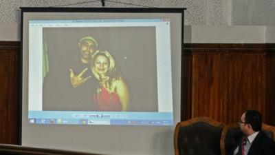 judge looks on as pictures are displayed during the trial of 20 indivuduals, including three Al-Jazeera journalists, in Cairo