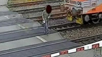 Man walks in front of train