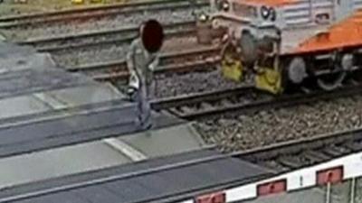 Man walks in front of train