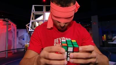 Rubik's cube champion solving while blindfolded