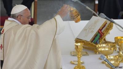 Pope Francis prepares the Eucharist during the canonisation mass of Popes John XXIII and John Paul II at St Peter's