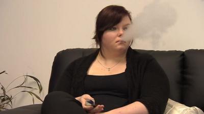 A woman smoking an electronic cigarette
