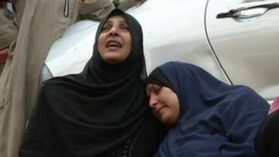 Women protest outside the court