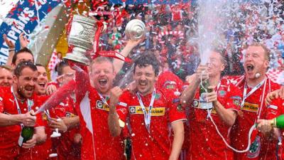 Cliftonville players celebrate lifting the Gibson Cup at Solitude