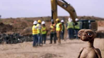 An E.T. doll is seen while construction workers prepare to dig into a landfill in Alamogordo, N.M., Saturday, April 26, 2014