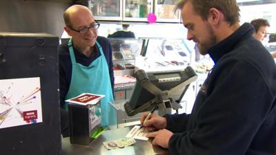 Nick Robinson serves in a fish and chip shop