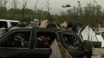 A helicopter in the background of aftermath from the tornado