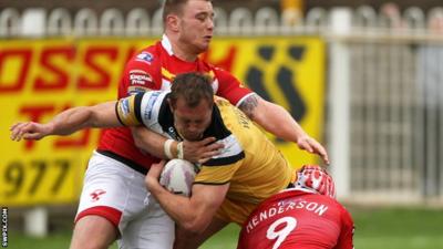 Castleford Tigers’ Scott Wheeldon is tackled by Sheffield Eagles’ Andrew Henderson