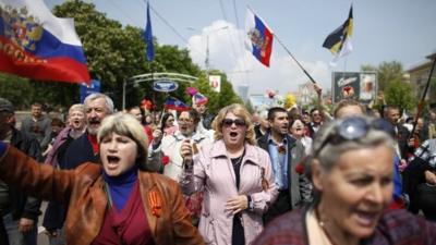 Demonstrators with Russian flags at May Day rally in Donetsk, Ukraine