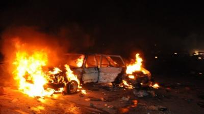 A car burns in Abuja, Nigeria