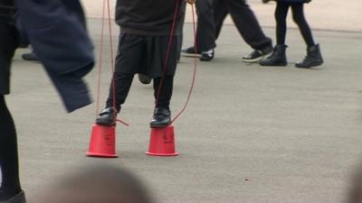 A child walking on stilts