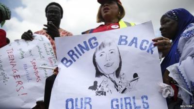 Protester holding sign reading 'Bring back our girls'