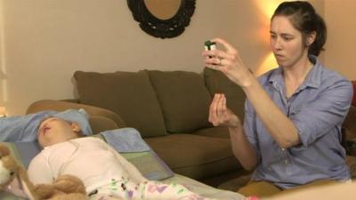 Nicole Mattison administers a drug to her baby daughter