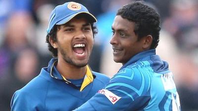 Dinesh Chandimal celebrates with wicket-taker Ajantha Mendis