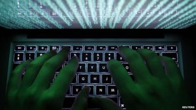 A man typing on a computer keyboard