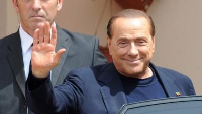 Silvio Berlusconi getting into car after his first day of community service