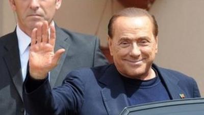 Silvio Berlusconi getting into car after his first day of community service