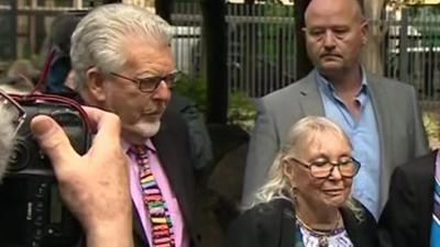 Rolf Harris and his wife arriving at court