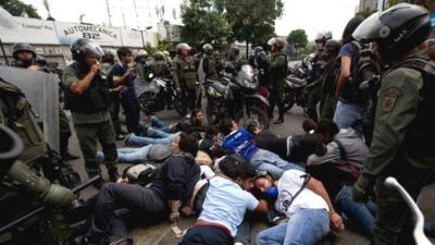 Police surround a group of anti-government demonstrators