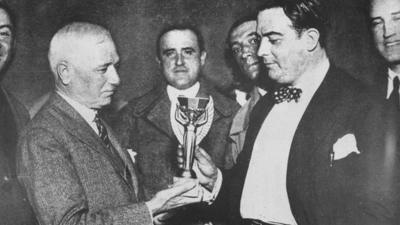 Fifa president Jules Rimet hands over the trophy to Uruguay