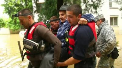 Recue workers carry elderly man