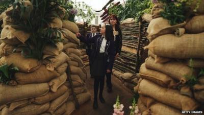 Visitors looking around a World War One themed garden at Chelsea Flower Show