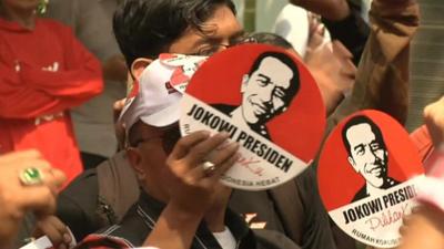 Crowd holding up Jokowi election signs