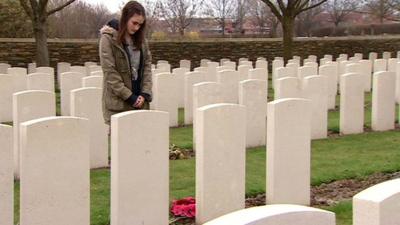 Charlotte praying by relative's grave