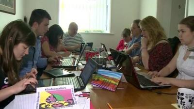 Family of James Male at their dining room table with laptops