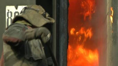 Man stoking a fire in Donetsk, Ukraine