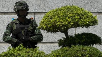 A Thai soldier stands guard as anti-government protest leaders meet with army chief General Prayut Chan-O-Cha