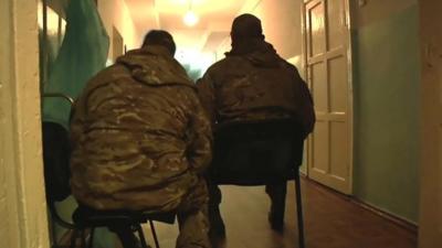 Ukrainian soldiers with backs to camera