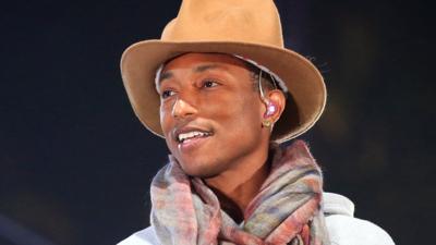 Pharrell Williams smiles on stage