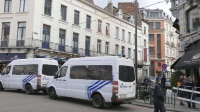 Police vans are parked around the scene of a shooting near the Jewish Museum in Brussels