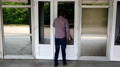 Election official outside closed polling station in Donetsk (25 May)