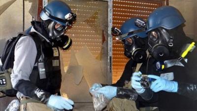 File photo - Members of the UN investigation team take samples from the ground in the Damascus countryside of Zamalka, Syria, on 29 August 2013