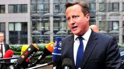 David Cameron talks to reporters