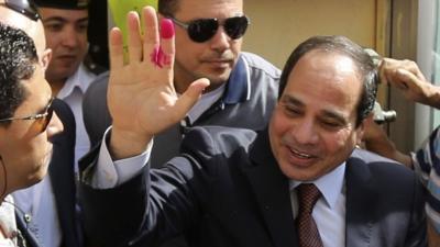 Abdel Fattah al-Sisi gestures after casting his ballot in Cairo, Egypt, 26 May 2014