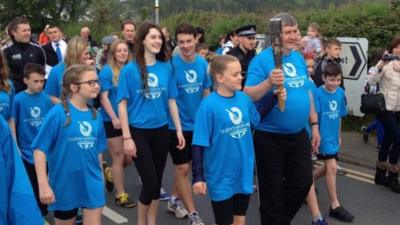 Roy Stephens carries the baton