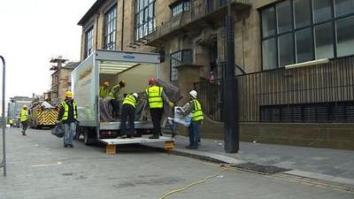 Workers retrieve items from the Charles Rennie Mackintosh building