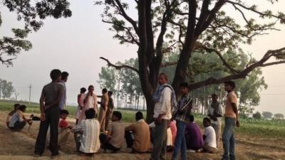 Villagers collect near tree where the girls were found in Badaun