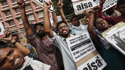 Students hold placards and shout slogans during a protest against the recent killings of two girls, in New Delhi May 30, 2014