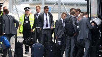 England football team at Luton Airport with suitcases