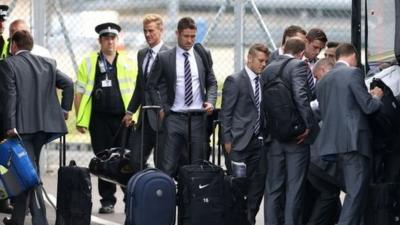 England football team at Luton Airport with suitcases