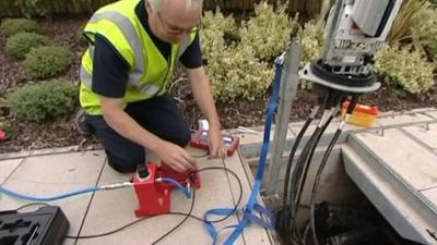 A engineer working on fibre optic cables