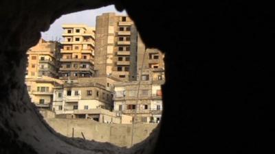 View through rubble onto buildings